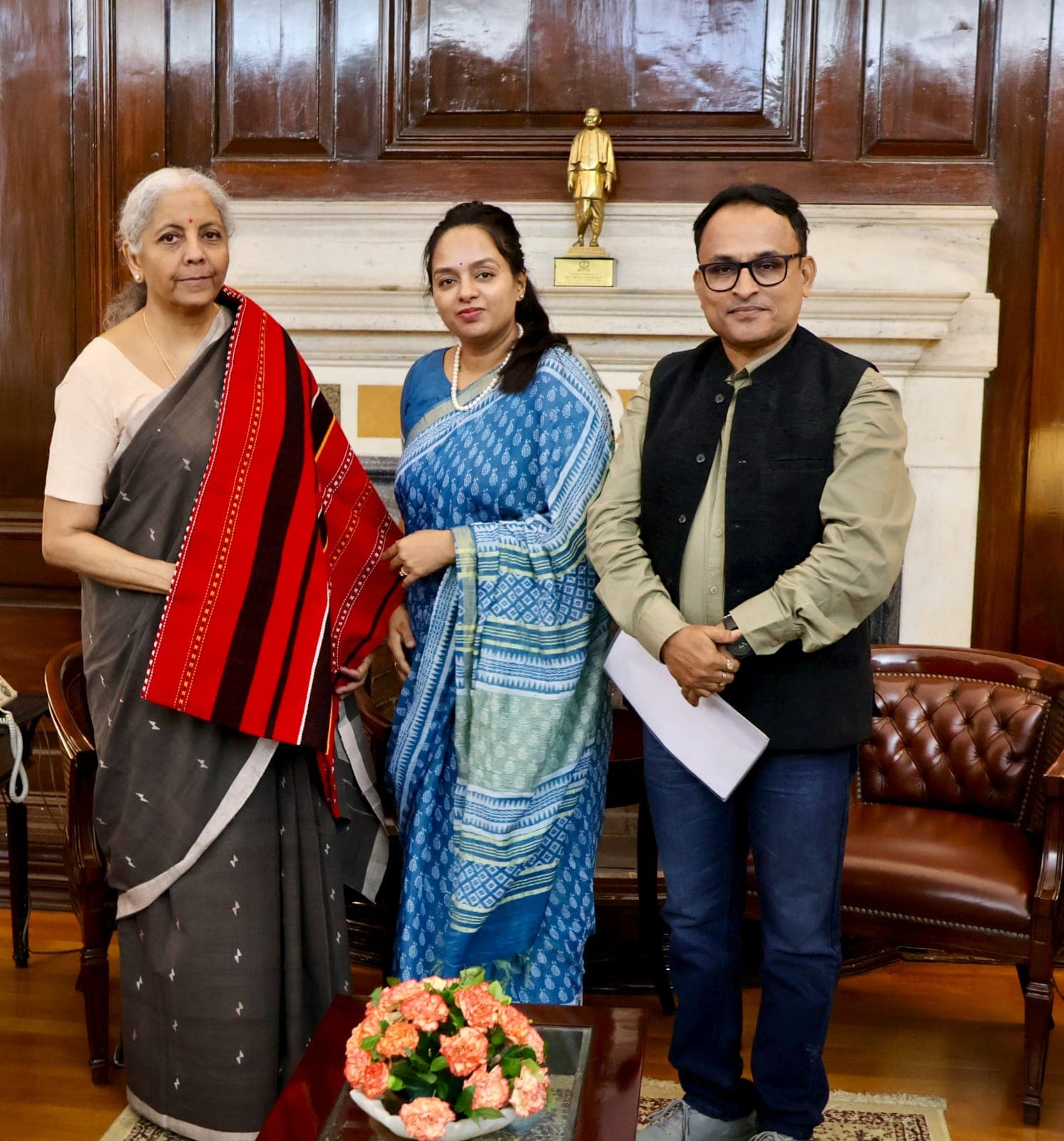 Photograph showing TASS Chairman Sri Adhinarayana Cherlopalli standing beside Union Finance Minister Smt. Nirmala Sitharaman, handing over a formal representation regarding tribal development initiatives.