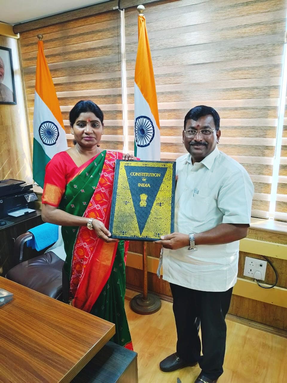 Group photograph of the TASS delegation meeting with the Chairperson and officials of the National Commission for Scheduled Tribes in a conference room setting.