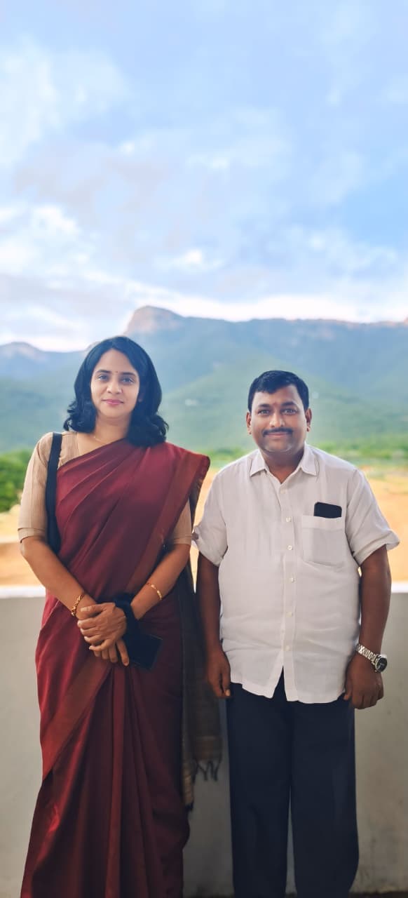 Photograph of Chairman Sri Adhinarayana Cherlopalli standing with and congratulating a uniformed female pilot from the SC/ST community.